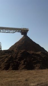 Biomass stackout pile with dust suppression system